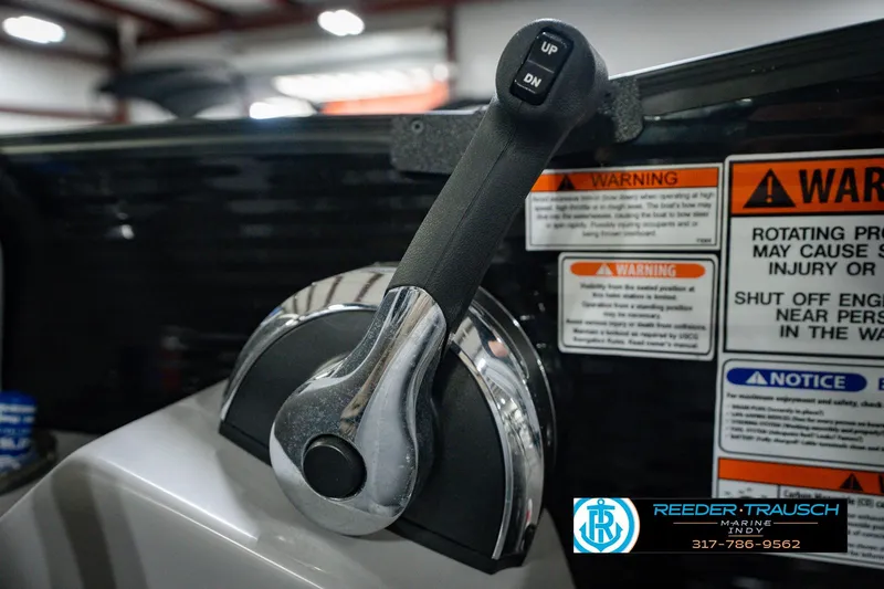 Slide: The Image of Throttle control lever on a 2022 Bennington 23 LTSB boat with warning labels. - 48