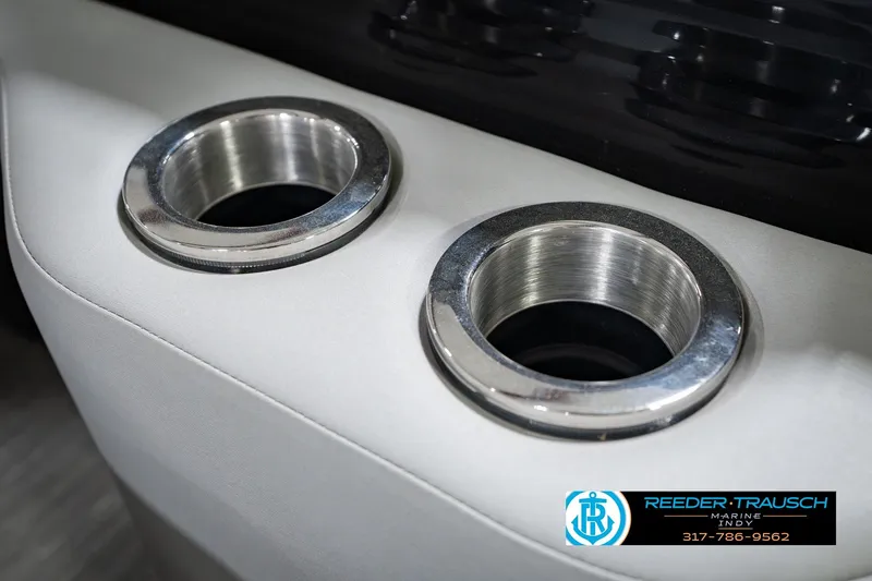 Slide: The Image of Cup holders on a 2022 Bennington 23 LTSB boat, featuring sleek metallic design. - 57