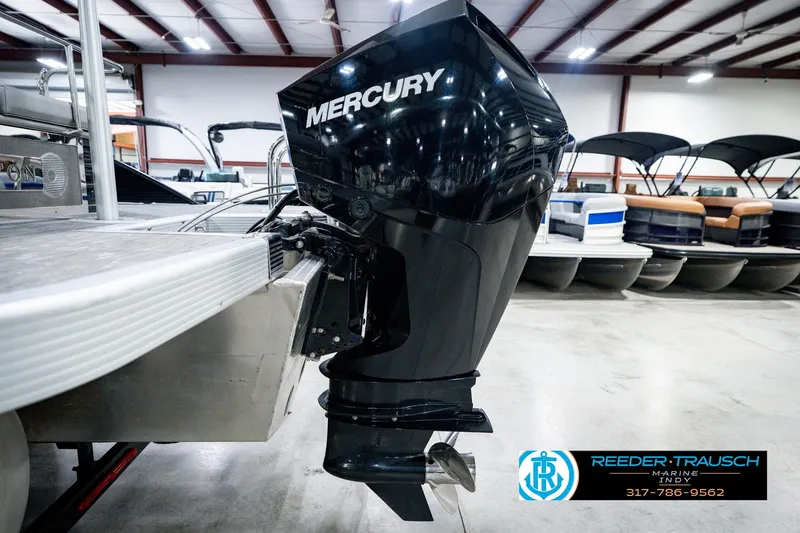 Slide: The Image of 2022 Bennington 23 LTSB pontoon boat with Mercury outboard motor in showroom. - 59