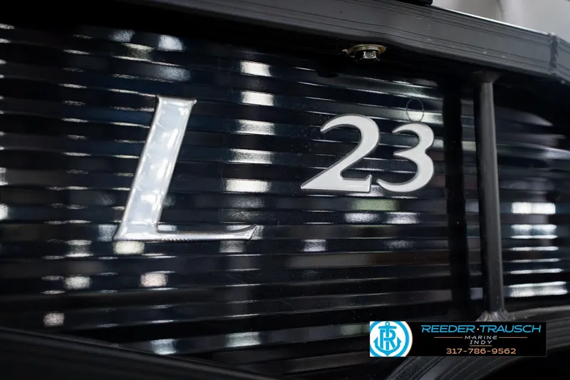 Slide: The Image of 2022 Bennington 23 LTSB boat model emblem with dealership logo and contact information. - 66