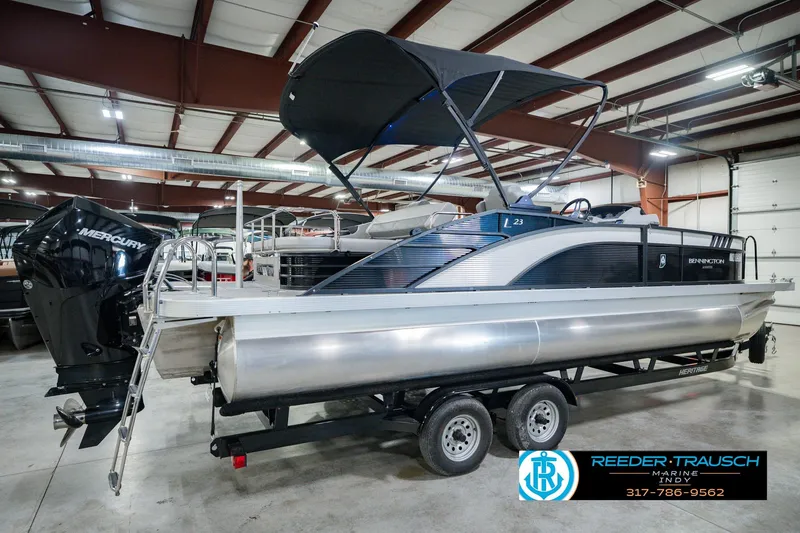 Slide: The Image of 2022 Bennington 23 LTSB pontoon boat with Mercury engine in indoor showroom. - 8