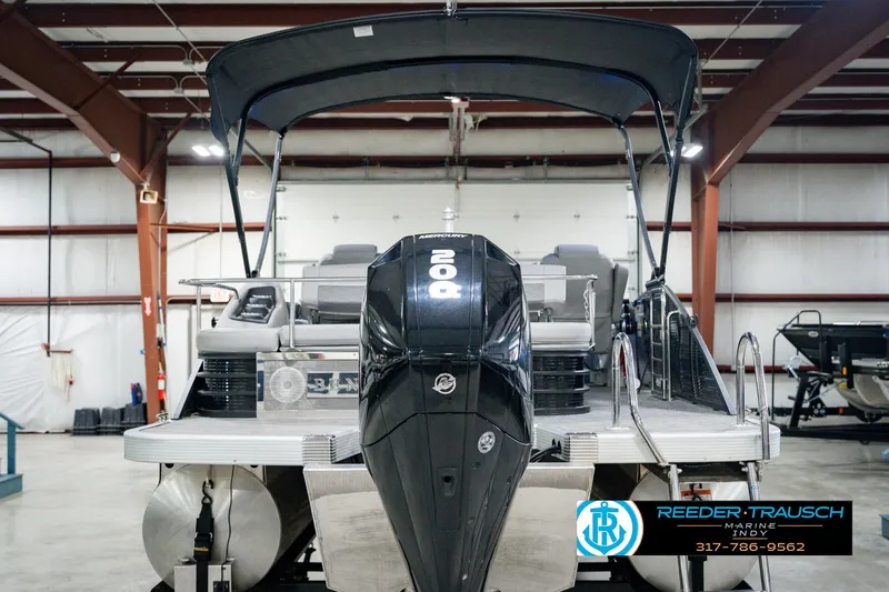 Slide: The Image of 2022 Bennington 23 LTSB pontoon boat with outboard motor in indoor showroom. - 9