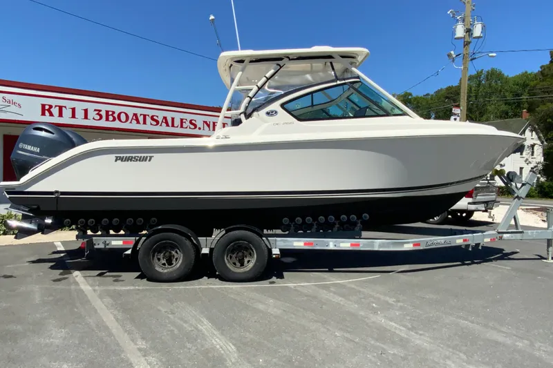 The Image of 2021 Pursuit DC 266 Dual Console boat on trailer at dealership. - 1