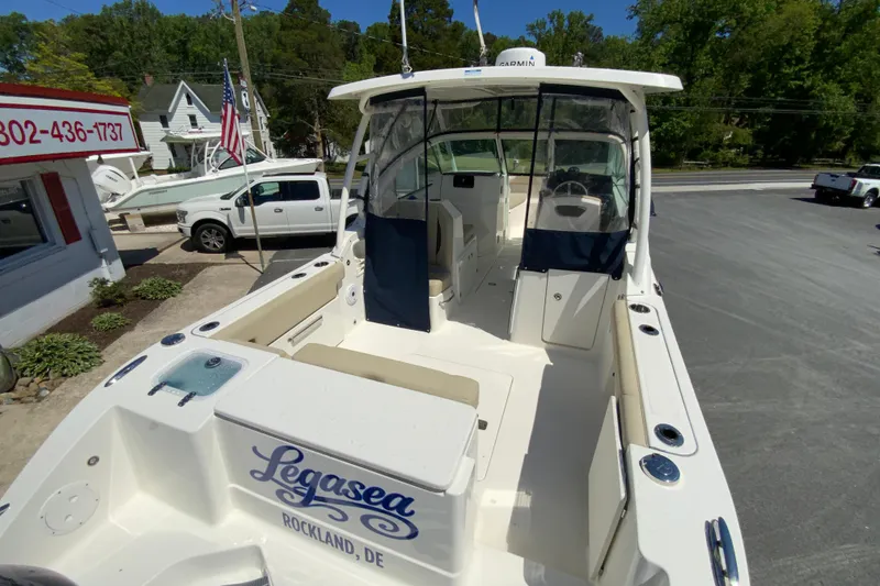 Slide: The Image of 2021 Pursuit DC 266 Dual Console boat in parking lot, featuring spacious seating and modern design. - 10