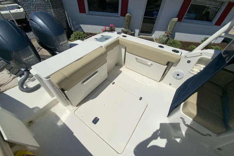 Slide: The Image of 2021 Pursuit DC 266 Dual Console boat interior with seating and twin 200 engines. - 11