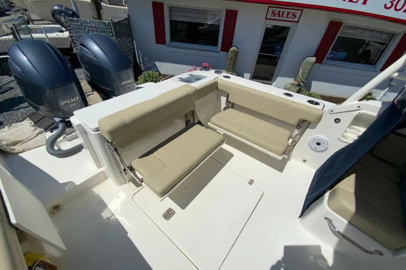 Slide: The Image of 2021 Pursuit DC 266 Dual Console boat with beige seating and twin 200 engines. - 13
