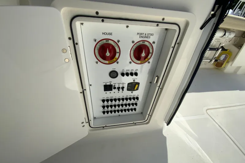 Slide: The Image of Electrical panel on a 2021 Pursuit DC 266 Dual Console boat, featuring switches and controls. - 19