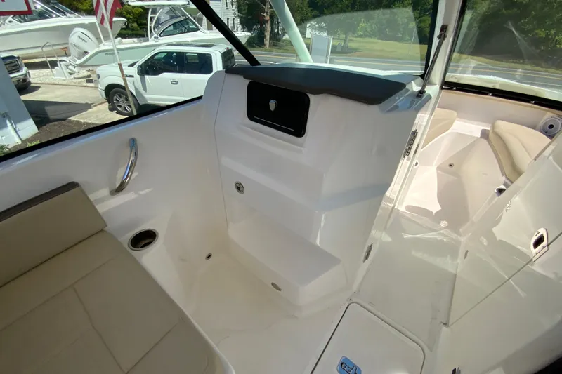 Slide: The Image of 2021 Pursuit DC 266 Dual Console interior with seating and storage compartments. - 20