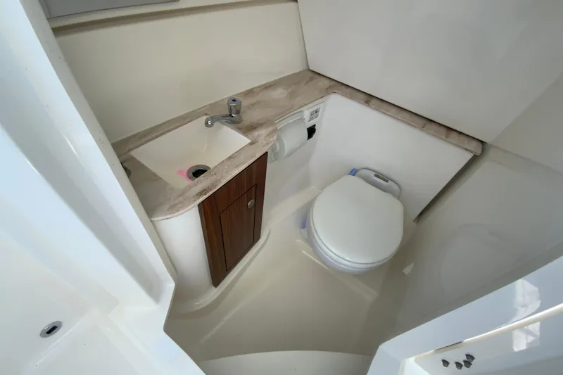 Slide: The Image of 2021 Pursuit DC 266 Dual Console boat bathroom with sink and toilet. - 22