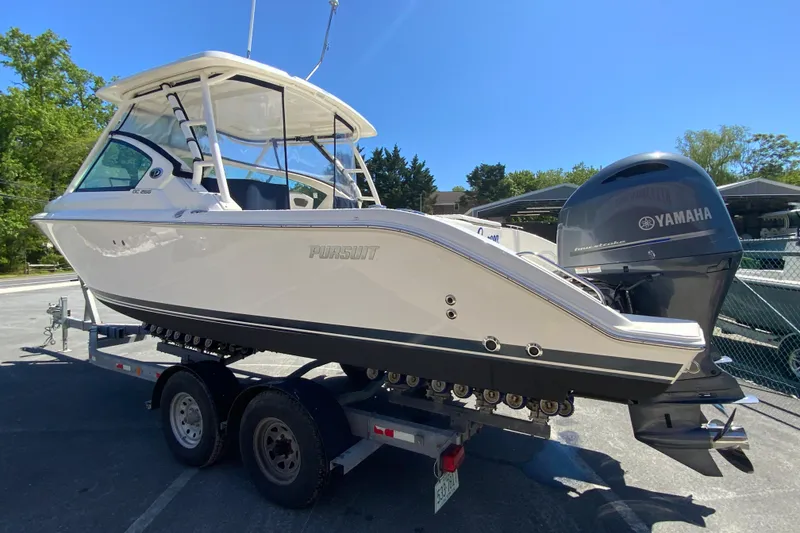 Slide: The Image of 2021 Pursuit DC 266 Dual Console boat on trailer with Yamaha engine. - 7