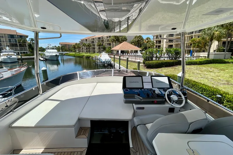 Slide: The Image of Luxurious 2024 Aicon Vivere 66 yacht interior with modern navigation system, docked in a scenic marina. - 100