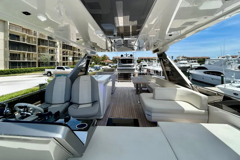 Slide: The Image of Luxurious 2024 Aicon Vivere 66 yacht interior with modern seating and helm, docked at marina. - 102