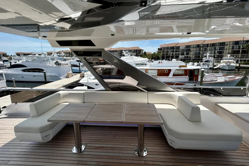 Slide: The Image of Luxurious Aicon Vivere 66 yacht deck with elegant seating, docked at a marina, 2024 model. - 104