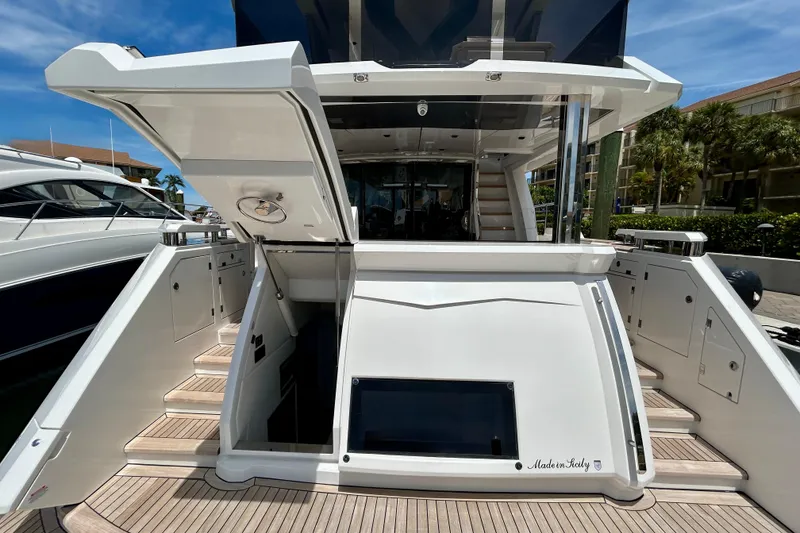 Slide: The Image of 2024 Aicon Vivere 66 yacht stern view with open hatch and teak deck. - 107