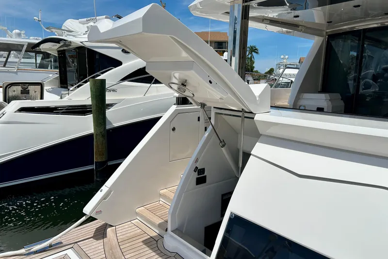 Slide: The Image of Luxury yacht Aicon Vivere 66, 2024 model, docked with open hatch and sleek design. - 108
