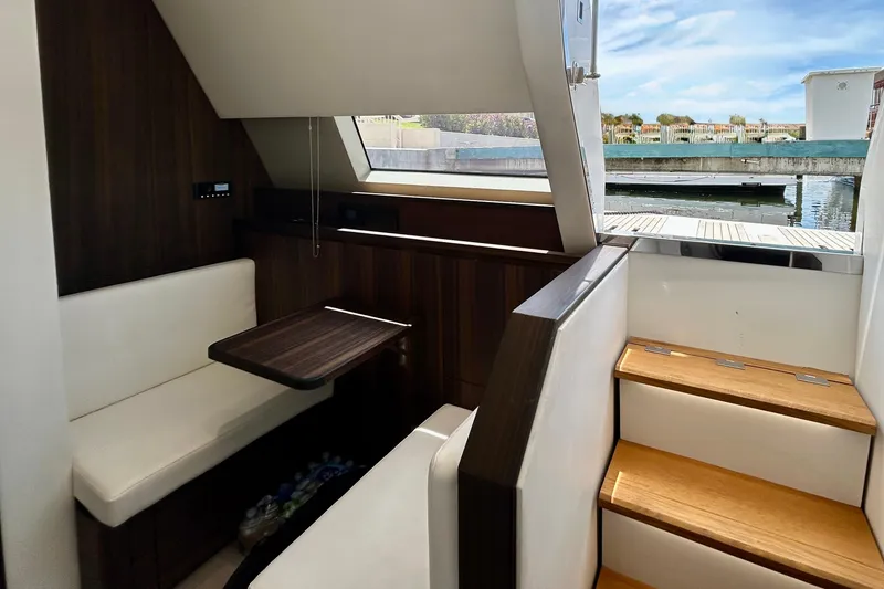 Slide: The Image of Crew Quarters of 2024 Aicon Vivere 66 yacht with elegant seating and wooden stairs. - 109