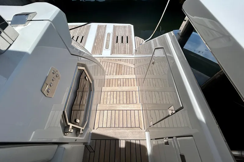Slide: The Image of 2024 Aicon Vivere 66 yacht deck with sleek wood finish and modern design elements. - 11