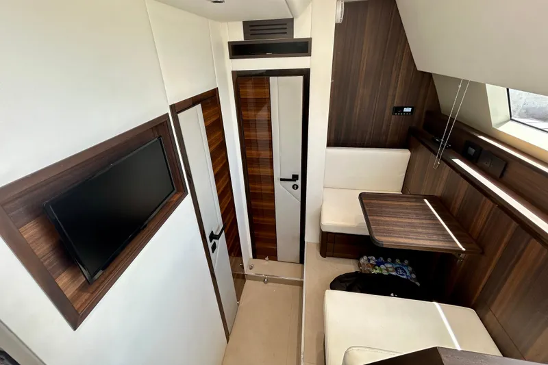 Slide: The Image of Crew Quarters of 2024 Aicon Vivere 66 yacht with modern wood finishes and seating area. - 110