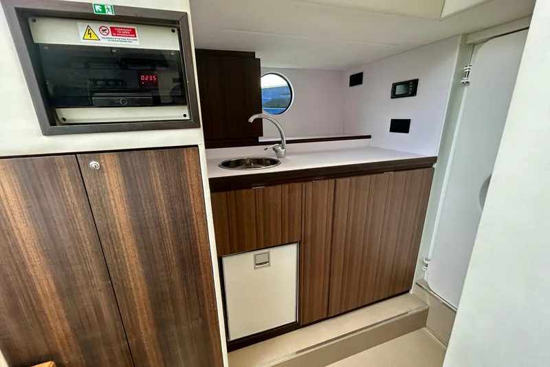 Slide: The Image of Crew Quarters of 2024 Aicon Vivere 66 yacht featuring a modern kitchenette with wood finish. - 113