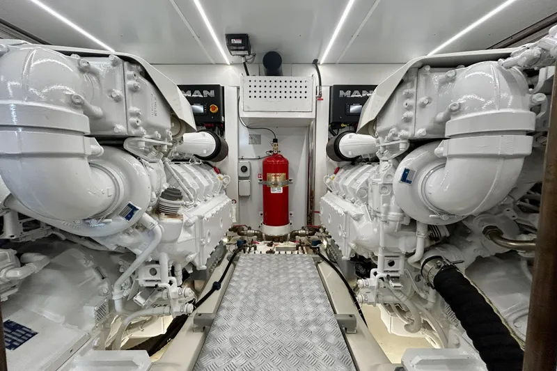 Slide: The Image of Engine room of 2024 Aicon Vivere 66 yacht with dual MAN engines and fire extinguisher. - 122