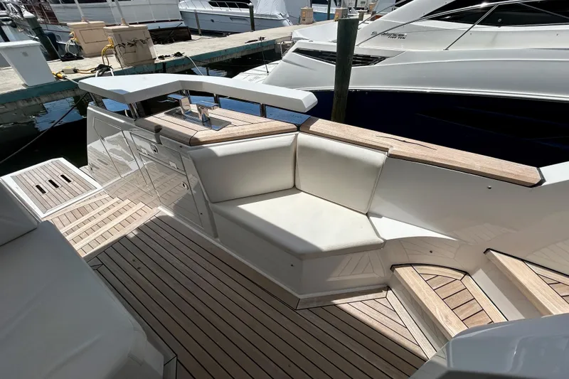 Slide: The Image of Luxurious 2024 Aicon Vivere 66 yacht deck with elegant seating and wooden flooring. - 13