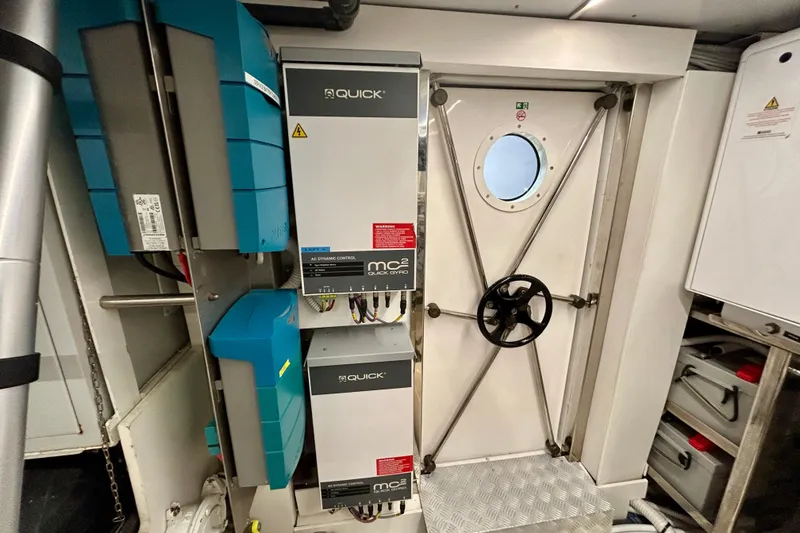 Slide: The Image of Engine room of 2024 Aicon Vivere 66 yacht with control panels and secure door. - 136