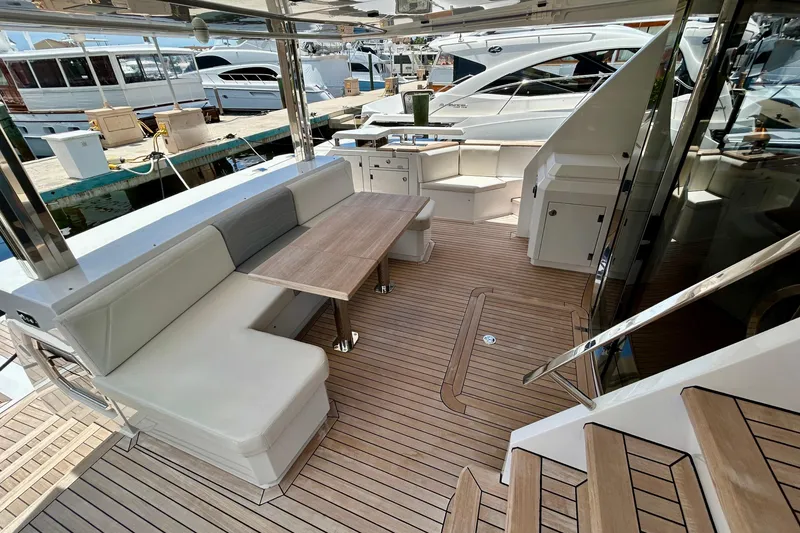 Slide: The Image of Luxurious 2024 Aicon Vivere 66 yacht interior with elegant seating and wooden flooring. - 16