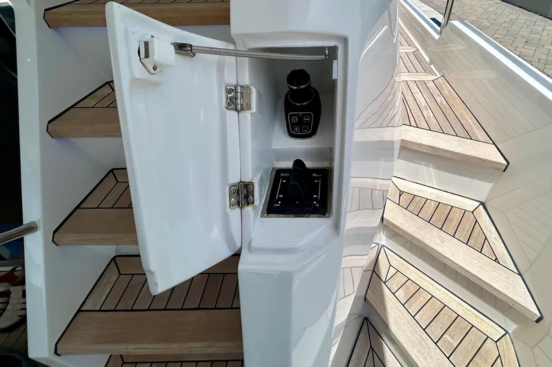 Slide: The Image of Control panel on the 2024 Aicon Vivere 66 yacht, featuring sleek wooden steps. - 19