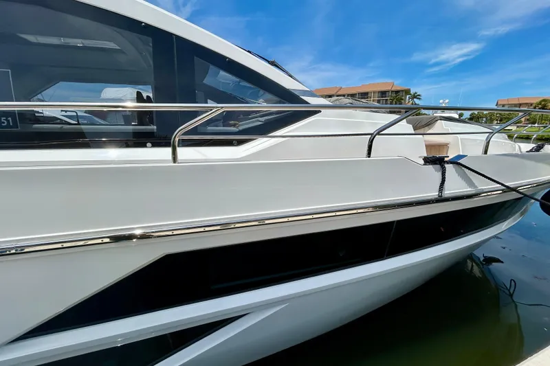 Slide: The Image of 2024 Aicon Vivere 66 yacht docked, showcasing sleek design and modern architecture. - 2
