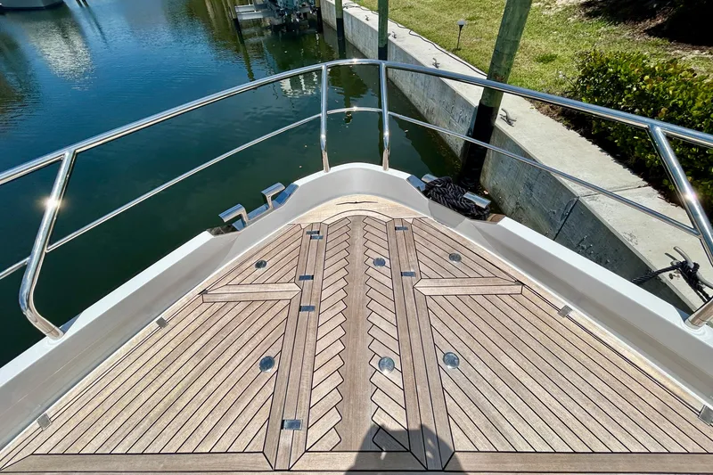 Slide: The Image of Bow view of 2024 Aicon Vivere 66 yacht with elegant teak decking and stainless steel railings. - 22