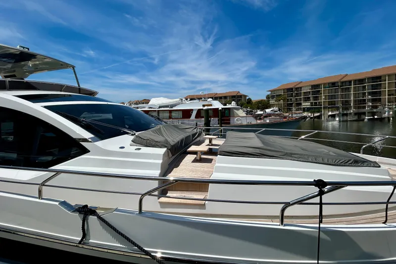 Slide: The Image of 2024 Aicon Vivere 66 yacht docked at marina under clear blue sky. - 3
