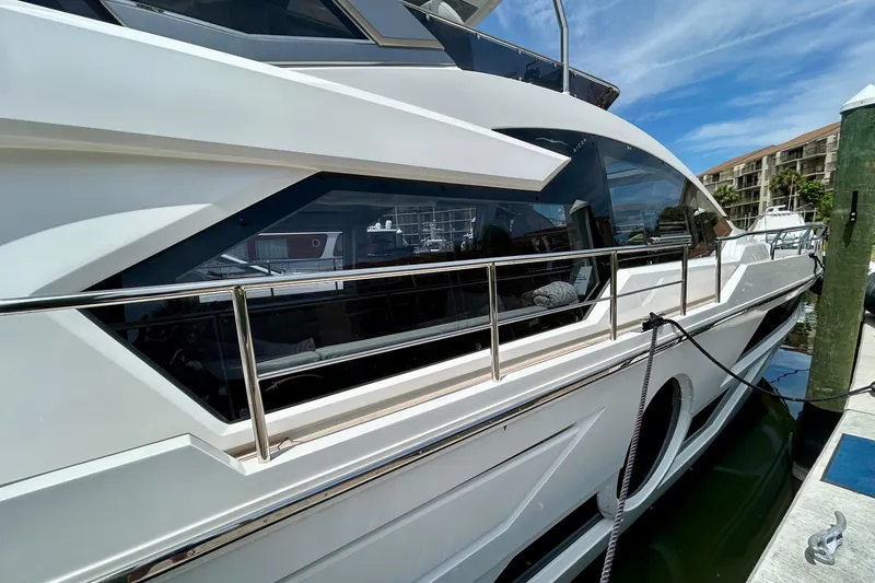 Slide: The Image of 2024 Aicon Vivere 66 yacht docked, showcasing sleek design and modern architecture. - 4
