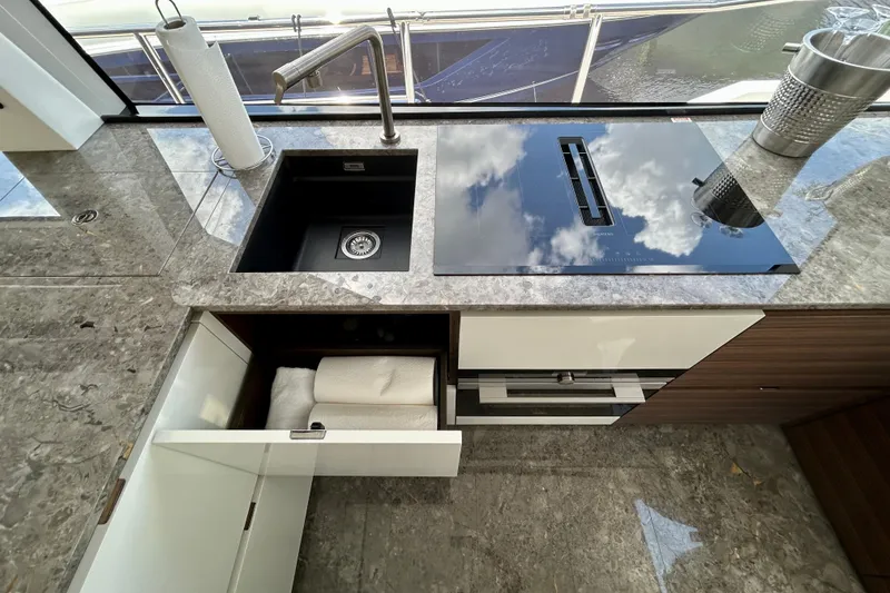 Slide: The Image of Modern kitchen on 2024 Aicon 66 Vivere yacht with sleek sink and stovetop. - 48