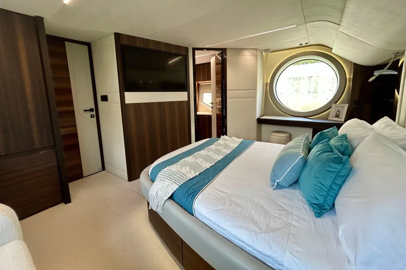 Slide: The Image of Luxurious bedroom interior of 2024 Aicon Vivere 66 yacht with modern design and circular window. - 69
