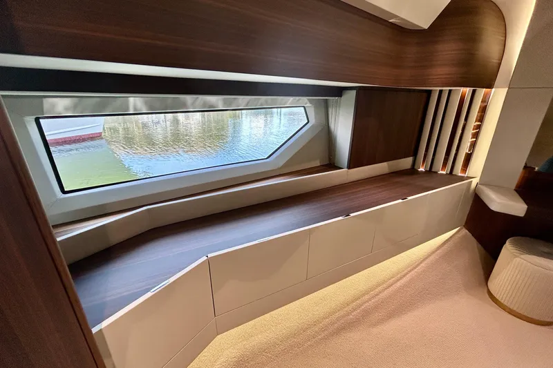 Slide: The Image of Luxurious interior of 2024 Aicon Vivere 66 yacht with elegant wood finishes and large window. - 78
