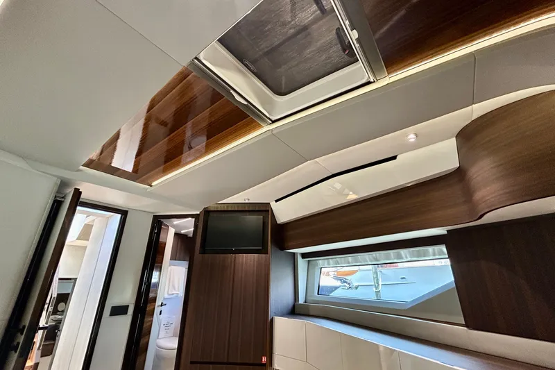 Slide: The Image of Luxurious interior of 2024 Aicon Vivere 66 yacht, featuring sleek wood finishes and modern design. - 80