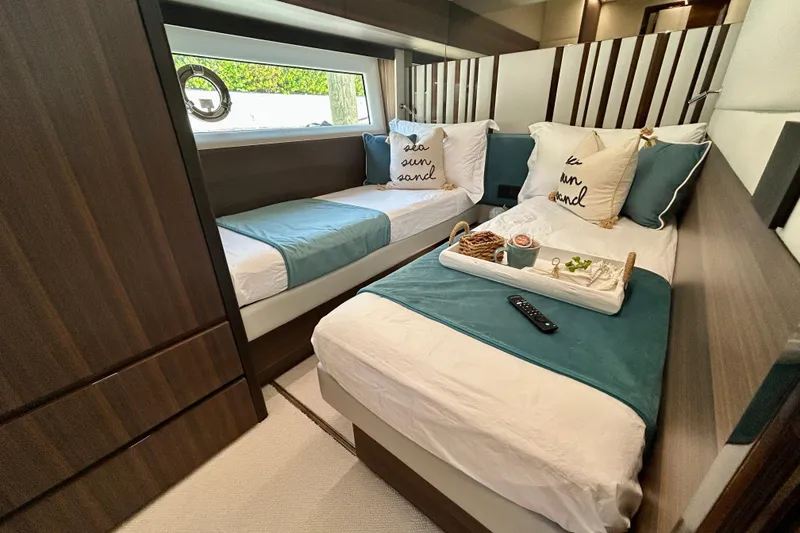 Slide: The Image of Luxurious twin cabin interior of 2024 Aicon Vivere 66 yacht with elegant bedding. - 85