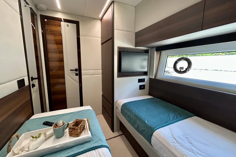 Slide: The Image of Luxurious cabin interior of 2024 Aicon Vivere 66 yacht with twin beds and modern decor. - 86