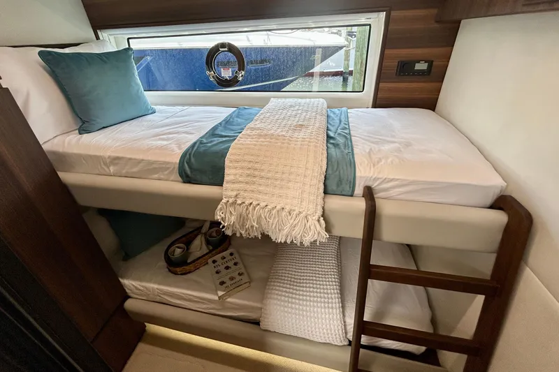 Slide: The Image of Luxurious 2024 Aicon Vivere 66 yacht cabin with cozy bunk beds and elegant decor. - 89