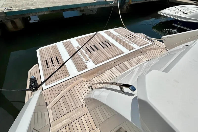 Slide: The Image of Luxury yacht Aicon Vivere 66, 2024 model, featuring elegant teak decking at the marina. - 9