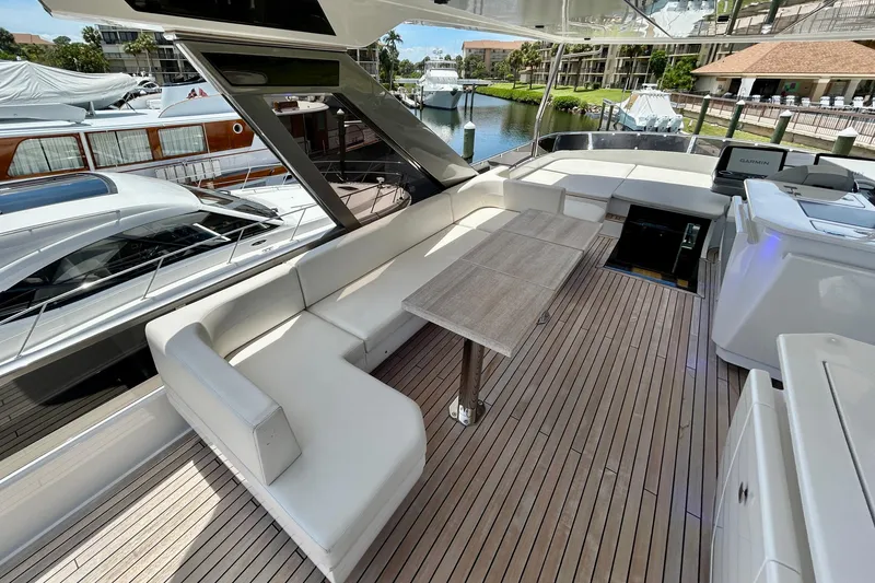 Slide: The Image of Luxurious 2024 Aicon Vivere 66 yacht deck with elegant seating and table setup. - 95