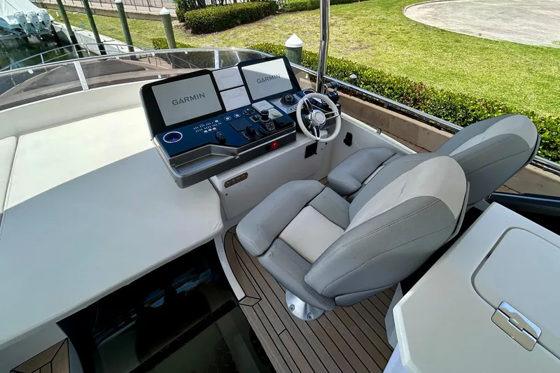 Slide: The Image of 2024 Aicon Vivere 66 yacht helm with Garmin navigation system and plush seating. - 98