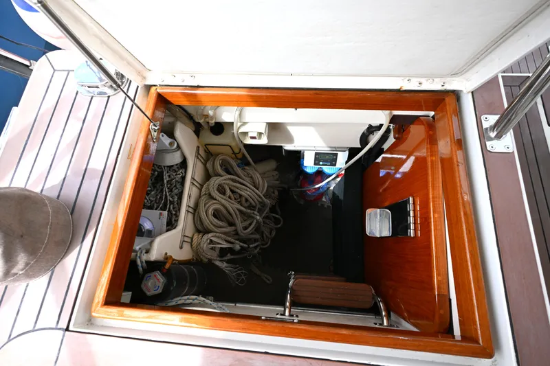 Slide: The Image of Open hatch on 2006 Waterline 50 boat, revealing ropes and equipment storage. - 100