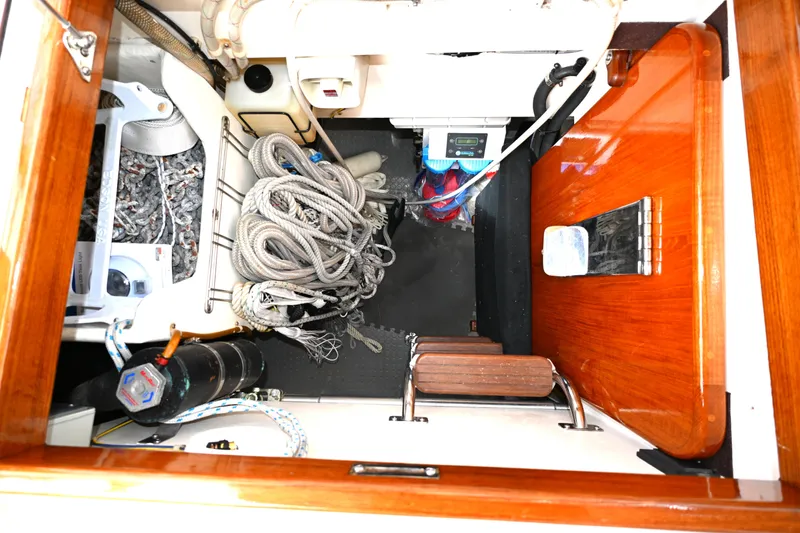 Slide: The Image of Interior view of a 2006 Waterline 50 sailboat showing ropes and equipment storage. - 101