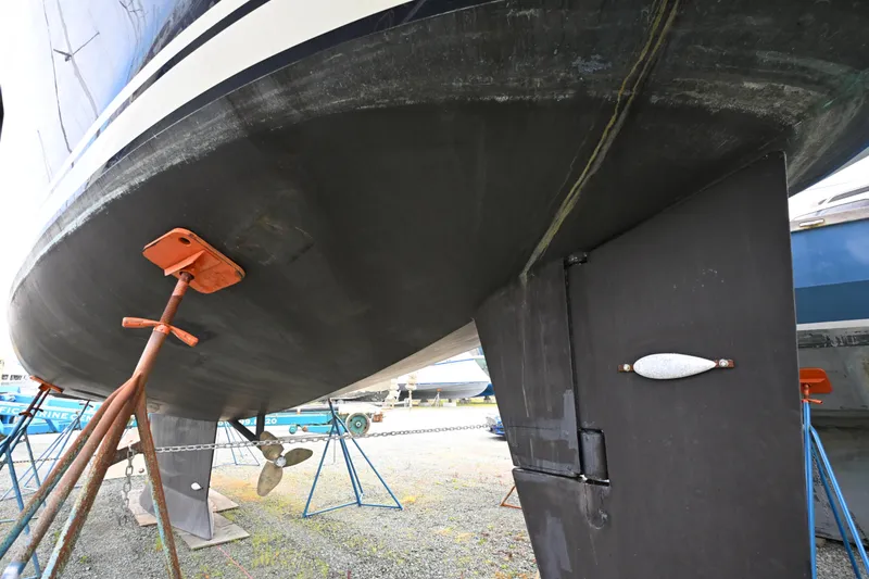 Slide: The Image of Underwater view of a 2006 Waterline 50 yacht on stands, showcasing hull and rudder. - 113