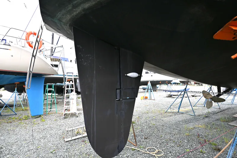 Slide: The Image of Underwater view of a 2006 Waterline 50 sailboat's rudder and propeller in a boatyard. - 115