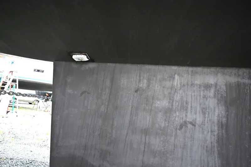 Slide: The Image of Underside view of a 2006 Waterline 50 boat hull with visible chain and ladder. - 119