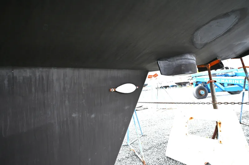 Slide: The Image of Close-up of 2006 Waterline 50 yacht hull in dry dock, showcasing keel and fittings. - 121