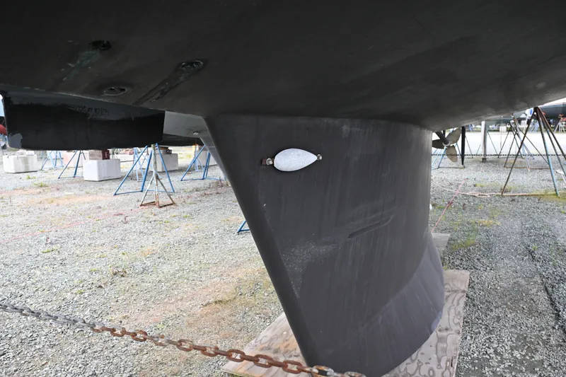 Slide: The Image of Underwater view of a 2006 Waterline 50 sailboat keel on a gravel boatyard. - 124
