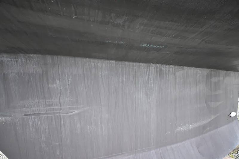 Slide: The Image of Close-up of a Waterline 50 yacht hull, 2006 model, showing sleek design and surface texture. - 125